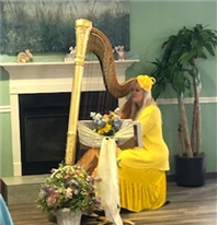 Victoria Victoria playing harp at Assisted Living Community Cabot Cove of Largo