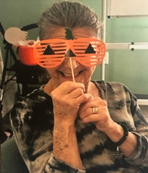Assisted Living assisted living resident Judy with pumpkin mask