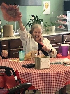Top Rated Assisted Living Community Cabot Cove of Largo assisted living resident waving her hat