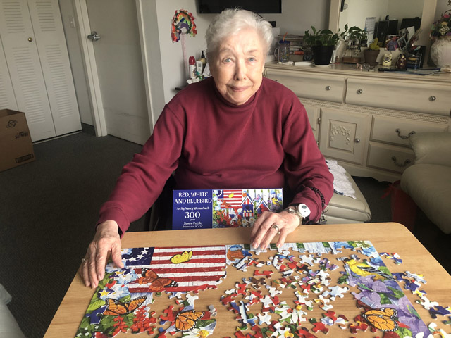 Assisted Living & Integrated Memory Care Community Cabot Cove of Largo assisted living resident enjoying puzzle time