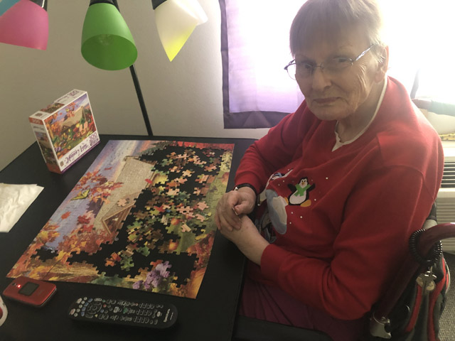 top rated assisted living on a place for mom assisted living resident with her puzzle