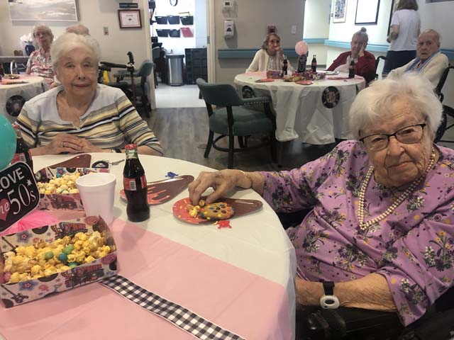 Header socializing at assisted living dance party