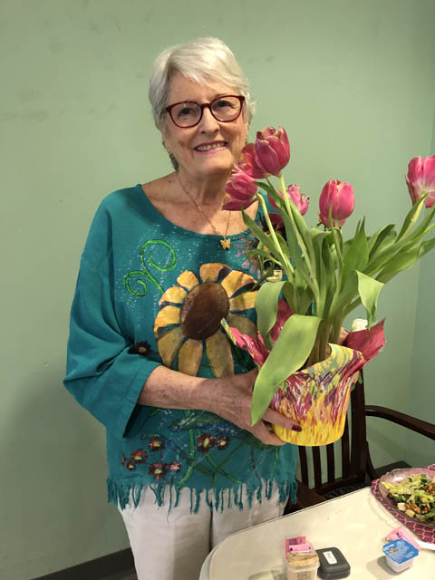 Header happy Cabot Cove resident with flowers